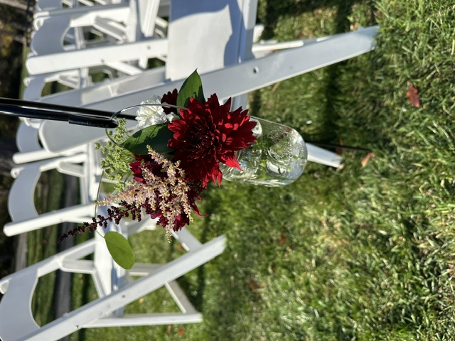 Burgundy mum and pink astilbe on ceremony shepherd's hooks