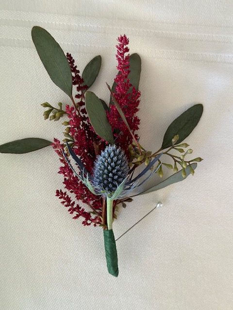 Burgundy astilbe and thistle boutonniere