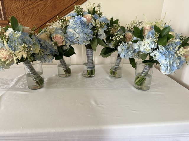 Light blue hydrangea and pink rose bridesmaid bouquets