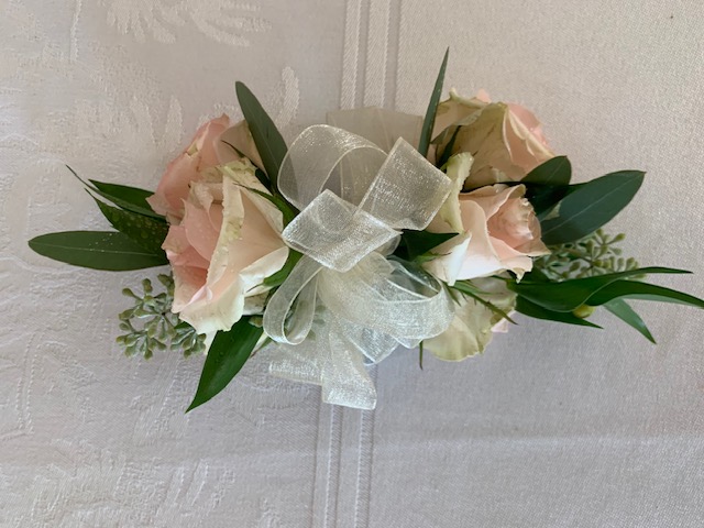 Light pink rose corsage with ribbon