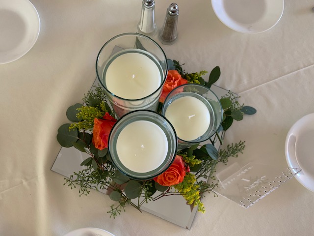 Orange rose and greenery centerpiece