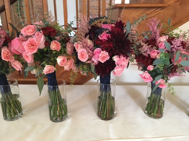 Bridesmaid bouquets of pink roses and pink astilbe