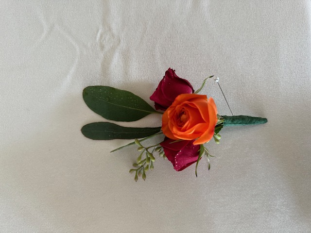 Red and orange sweetheart rose boutonniere