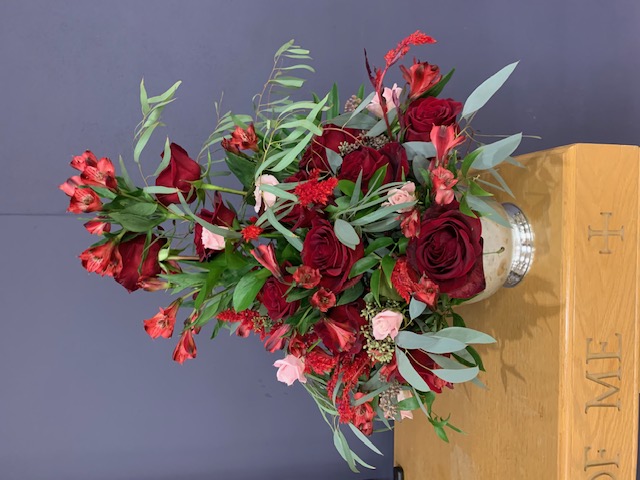 Red rose and alstroemeria church ceremony arrangement