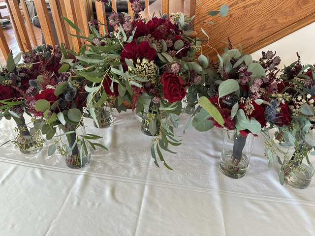 Red rose and alstroemeria bridesmaid bouquets