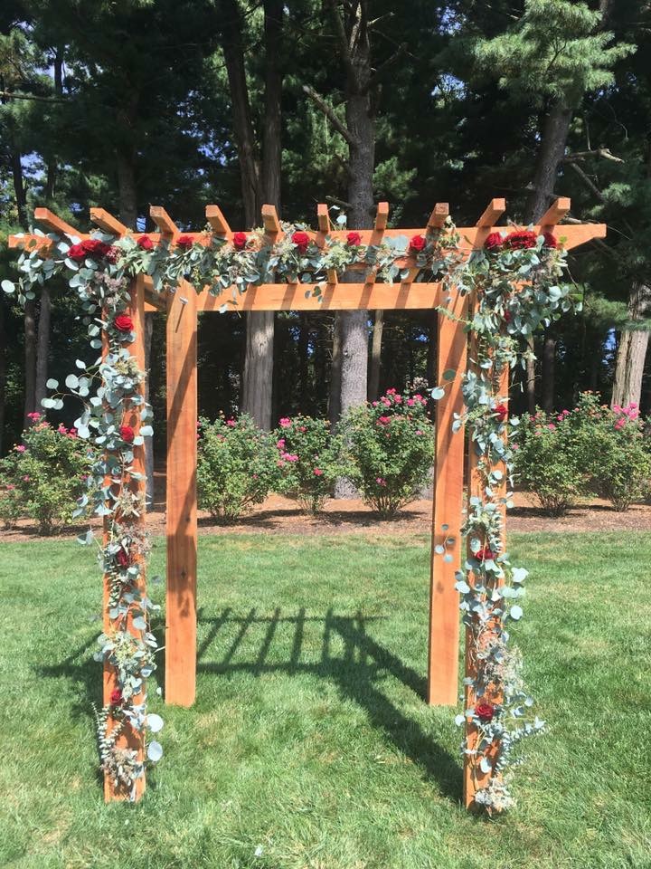 Red rose and greenery ceremony arbor
