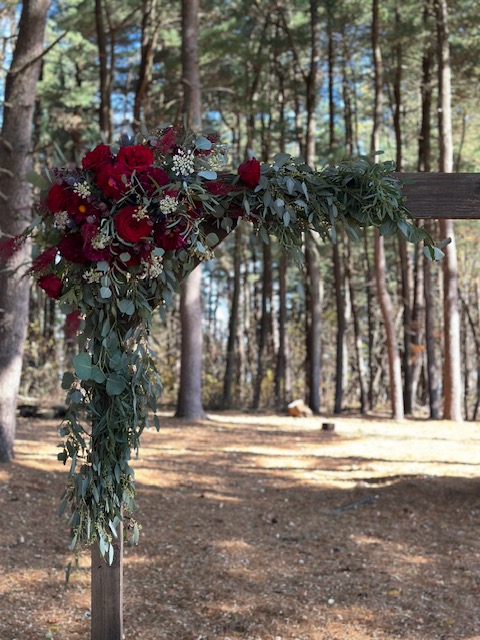 Red rose and greenery arbor swag