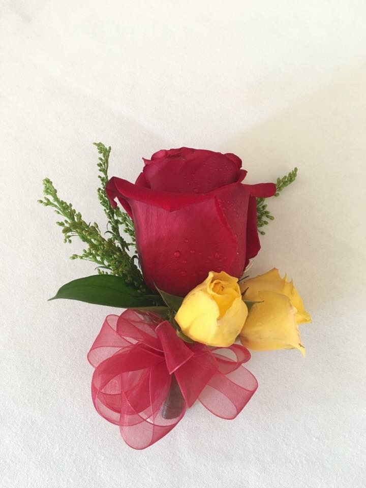 Red and yellow sweetheart rose pinned corsage with ribbon