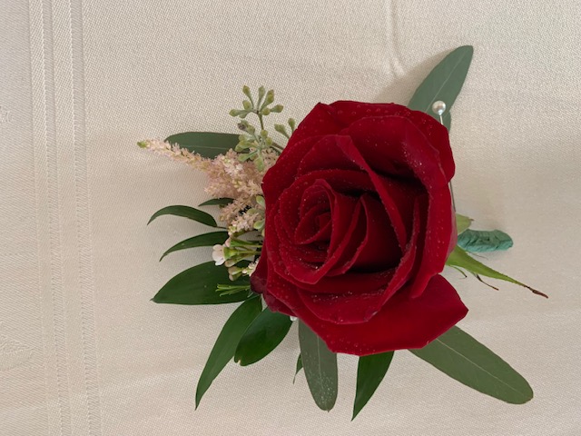 Red rose and seeded eucalyptus boutonniere