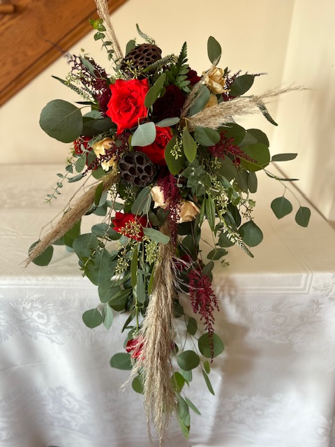 Red rose, burgundy mum, and greenery cascade bouquet