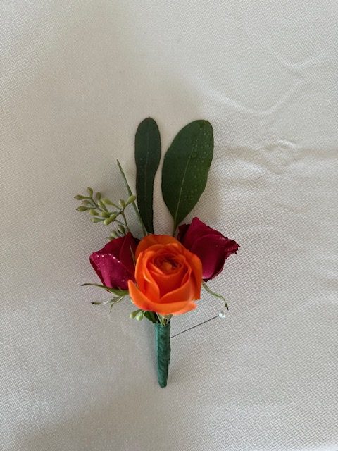 Red and orange sweetheart rose boutonniere