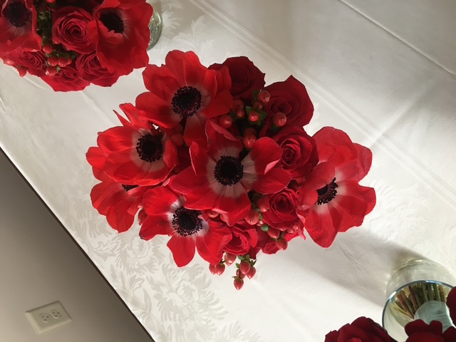 Bridesmaid bouquets of red anemones and hypericum berries