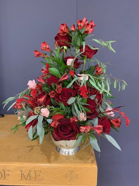 Red rose and alstroemeria church ceremony arrangement
