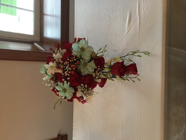 Red rose cascade bridal bouquet with painted-blue accents
