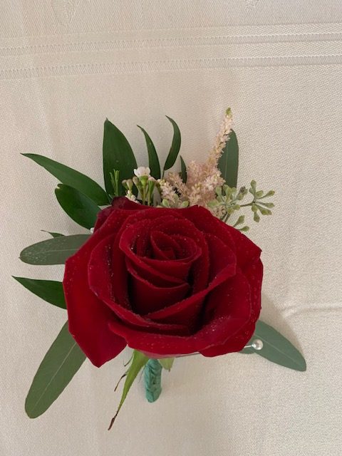 Red rose and seeded eucalyptus boutonniere