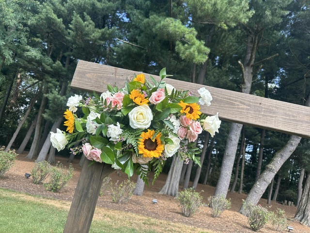 Sunflower, pink, and white rose arbor swag