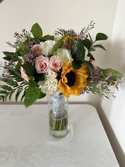 Sunflower, pink rose, and white hydrangea bouquet