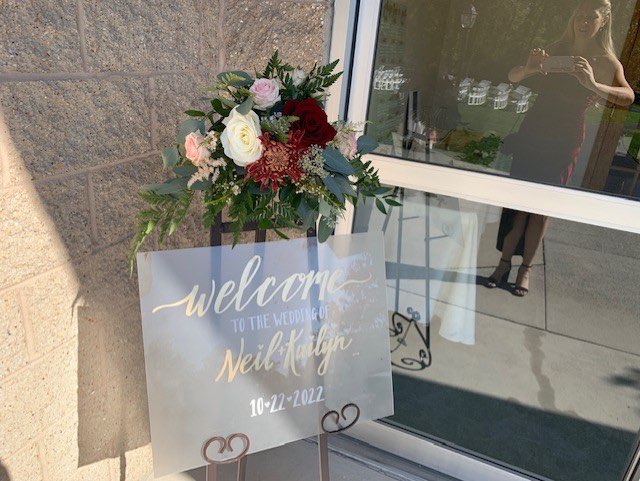 Floral arrangement on a wedding welcome sign