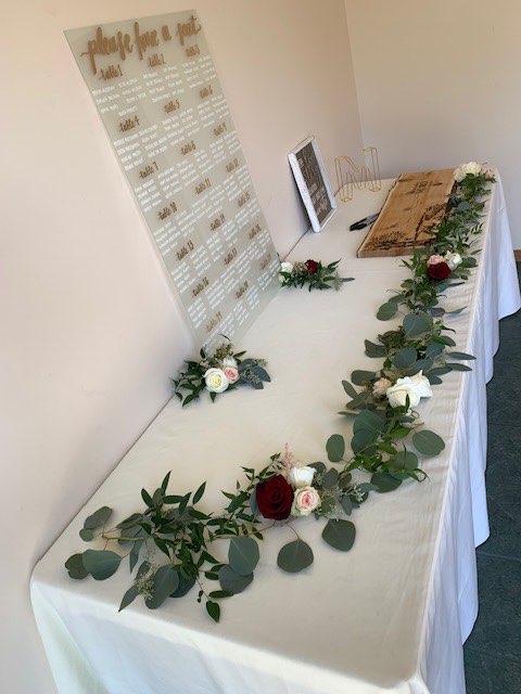 Greenery garland with roses on a welcome table