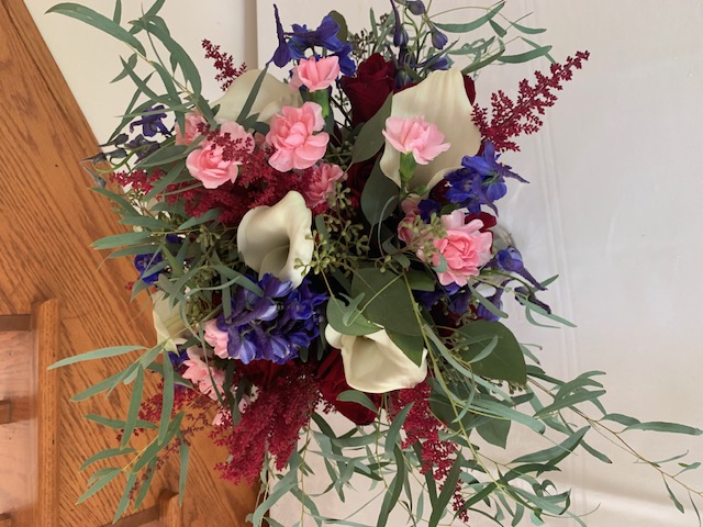 White calla lily, pink mini carnation, and burgundy astilbe bouquet