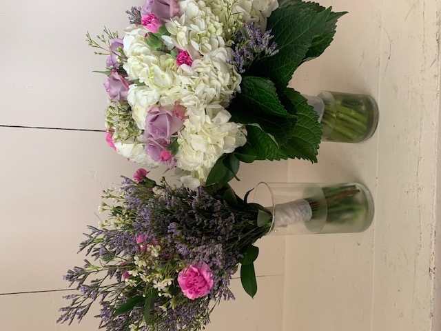 White hydrangea, purple rose, and pink mini carnation bouquet