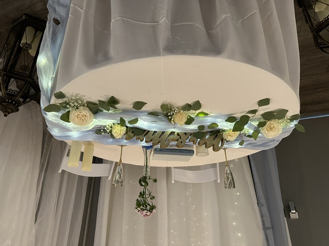 White roses and loose greenery for a sweetheart table