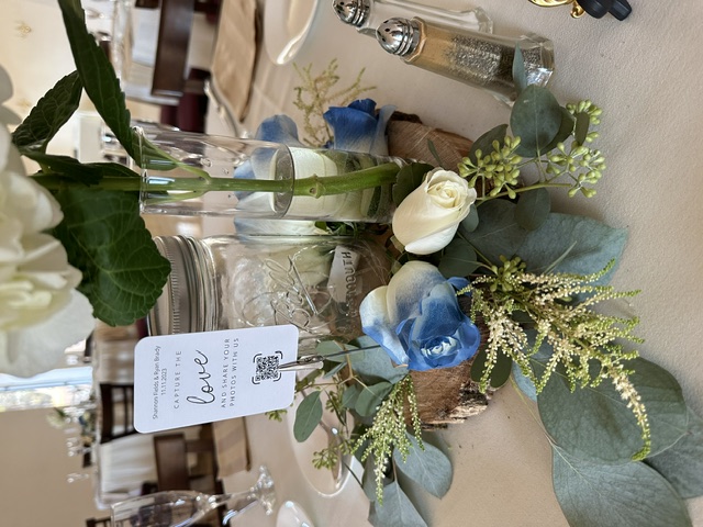 White rose centerpiece with navy-tipped roses