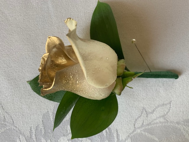 Gold-tipped white rose boutonniere