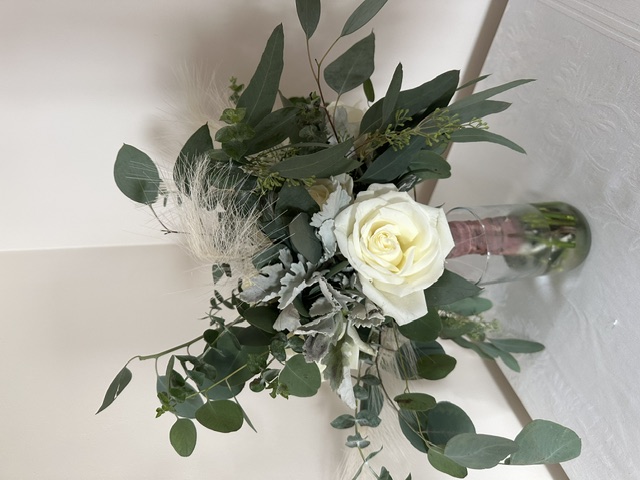 White rose bouquet with feathers and greenery
