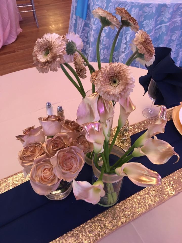 Gold-tipped white rose, gerbera daisy, and calla lily centerpiece