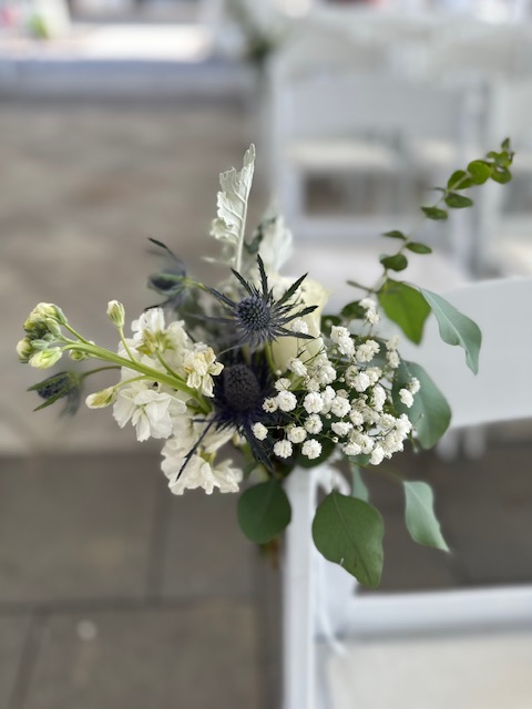 White stock and baby's breath ceremony chair decoration