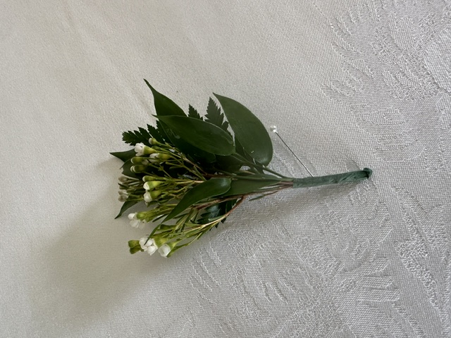 White wax flower and greenery boutonniere