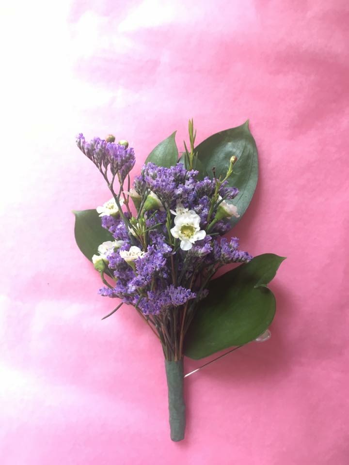 White wax flower and purple accent boutonniere