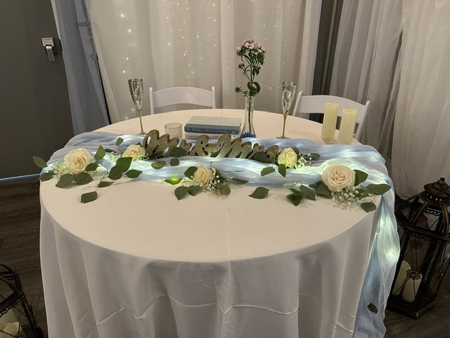 White roses and loose greenery for a sweetheart table