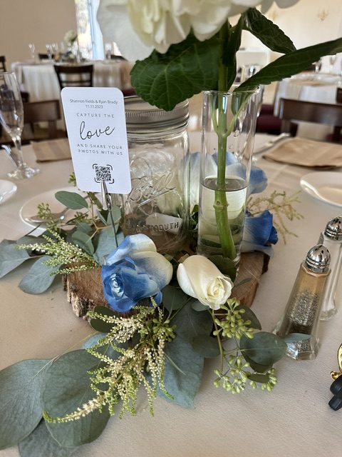 White rose centerpiece with navy-tipped roses