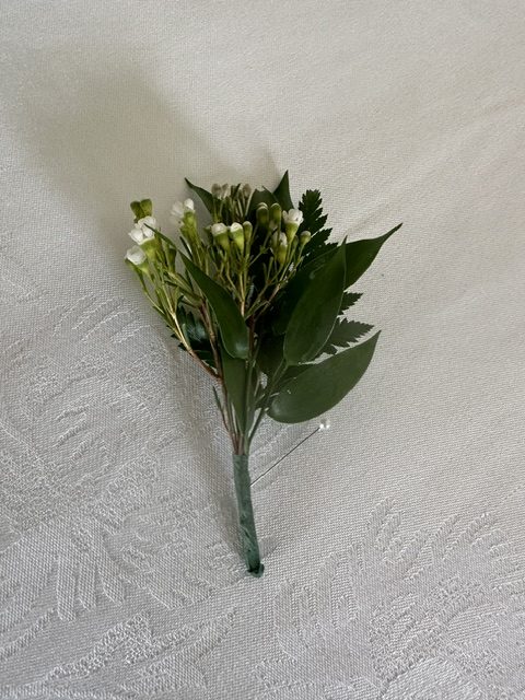 White wax flower and greenery boutonniere